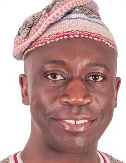 Timothy Mukoba, photographed smiling in a patterned cap and shirt